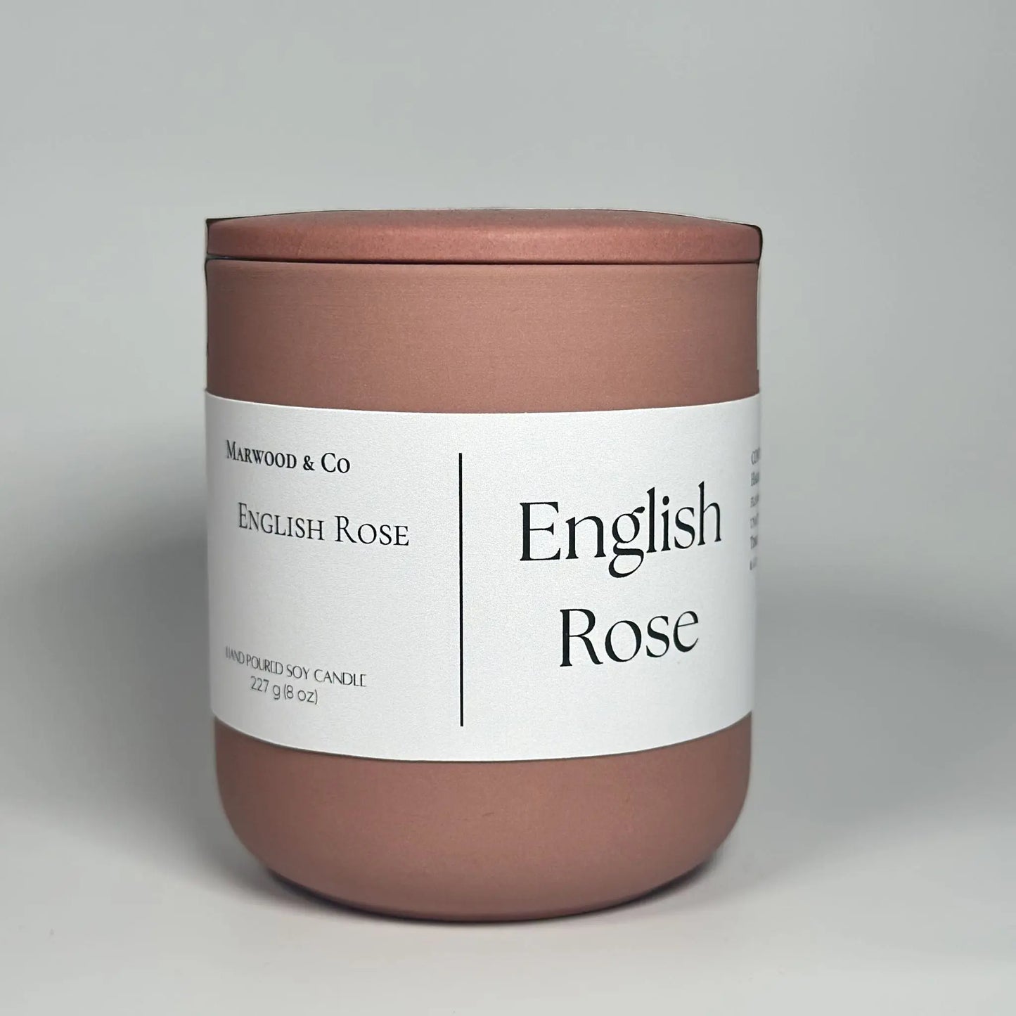 English rose scented candle, pink ceramic jar, luxury candle front view 
