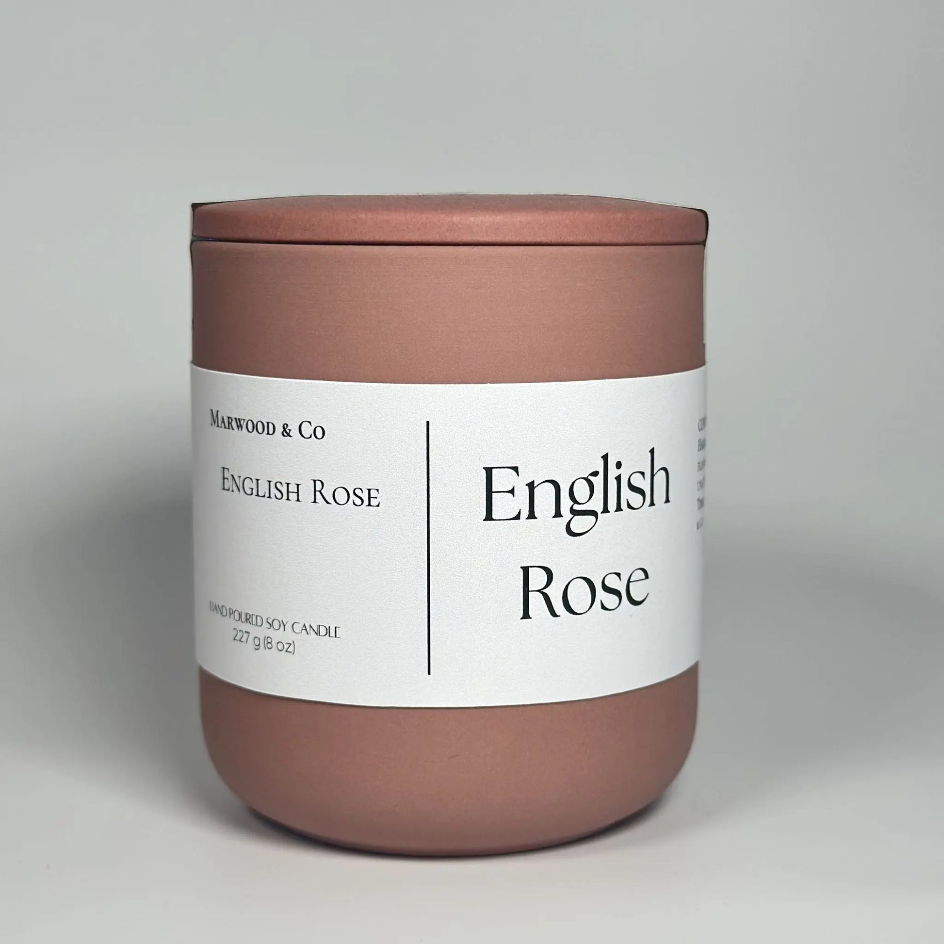 English rose scented candle, pink ceramic jar, luxury candle front view 
